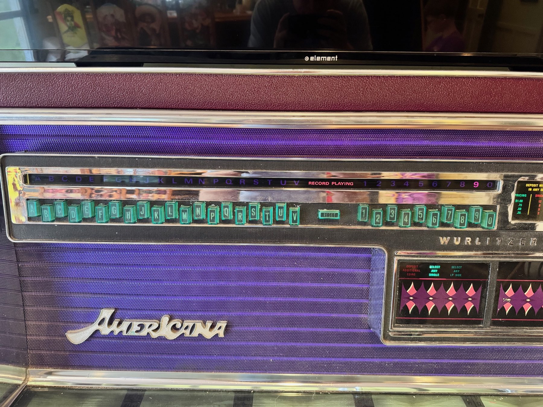 Close-up of the glowing green Wurlitzer selection buttons